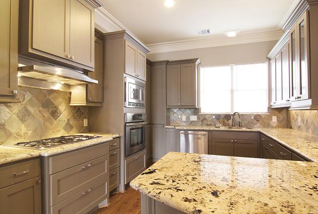 1138 Robbie Street Houston, TX 77009 - Photo 7 of 17 a kitchen with stainless steel appliances kitchen island granite countertop a sink stove and refrigerator