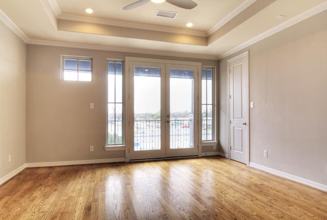 1138 Robbie Street Houston, TX 77009 - Photo 9 of 17 an empty room with wooden floor and windows