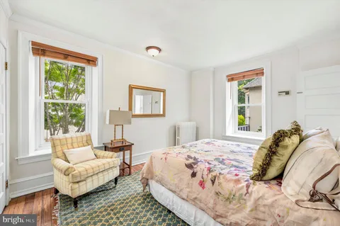 a bedroom with bed and a window