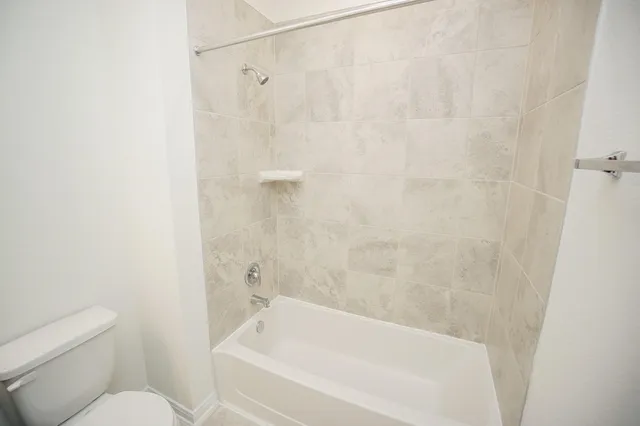 a bathroom with a bathtub and a toilet