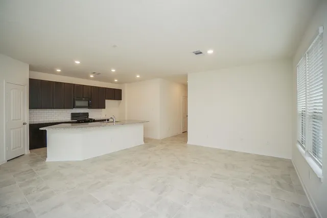 a view of kitchen with stainless steel appliances cabinets