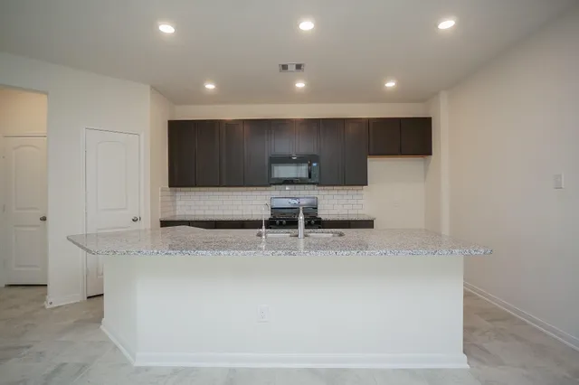 a kitchen with a sink and a refrigerator