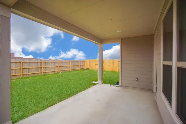 a view of a backyard with wooden fence