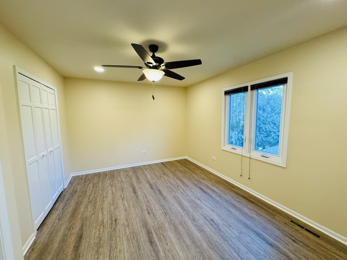 1398 East Gartner Road Naperville, IL 60540 - Photo 16 of 31 a view of empty room with wooden floor and fan