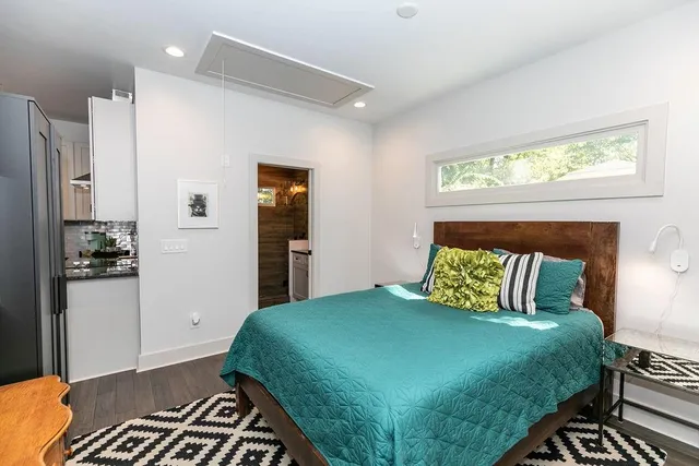 a bedroom with a bed and wooden floor