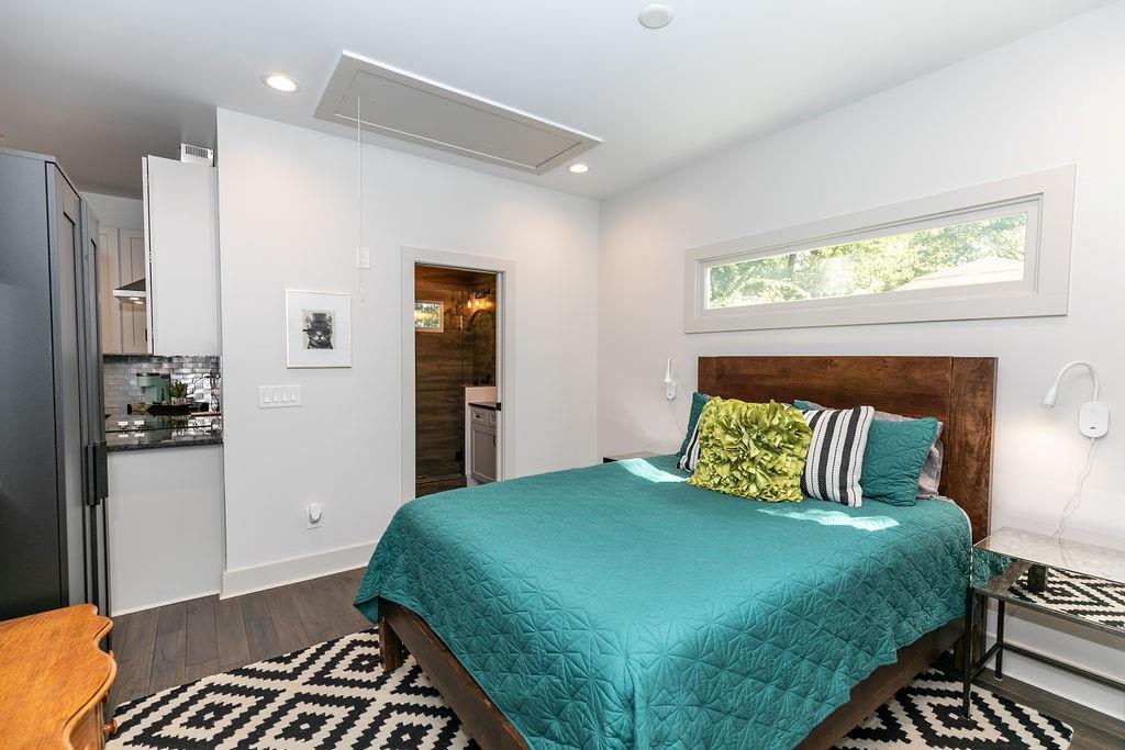 1084 Sanders Avenue Southeast, Unit B Atlanta, GA 30316 - Photo 16 of 28 a bedroom with a bed and wooden floor