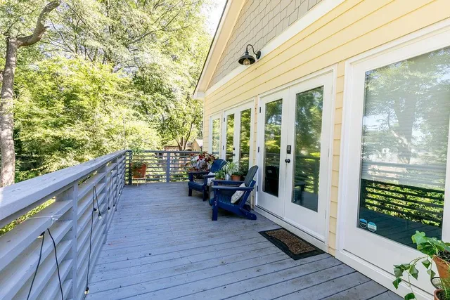 a balcony with furniture and wooden floor