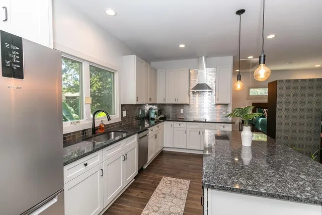 a kitchen with counter top space cabinets and appliances