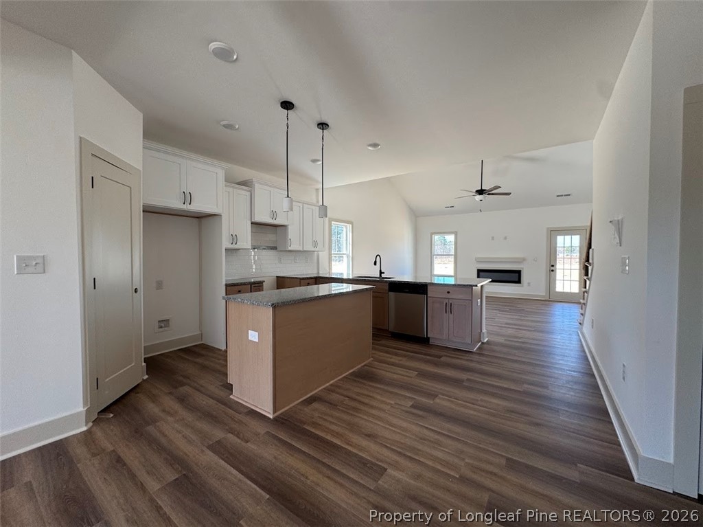 9844 Rockfish Road Raeford, NC 28376 - Photo 20 of 32 a large kitchen with stainless steel appliances kitchen island a large counter top and wooden floors
