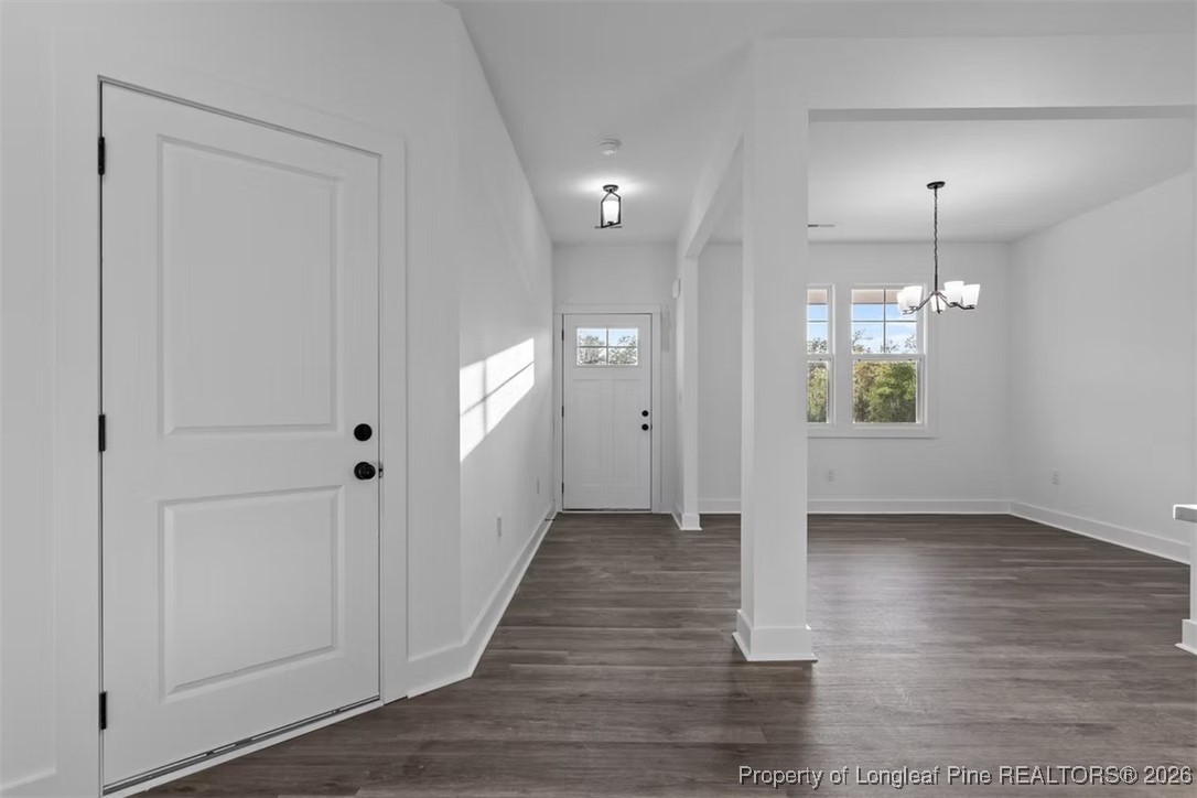 9844 Rockfish Road Raeford, NC 28376 - Photo 2 of 32 an empty room with wooden floor sink and mirror