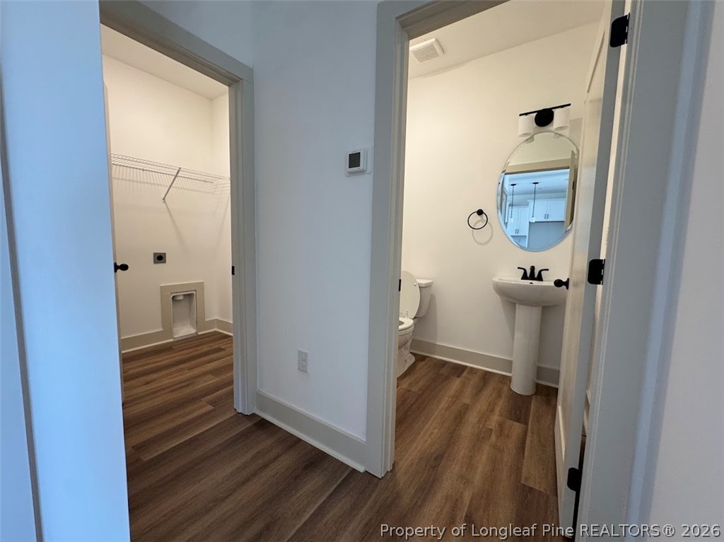 9844 Rockfish Road Raeford, NC 28376 - Photo 21 of 32 a view of a hallway with wooden floor and closet