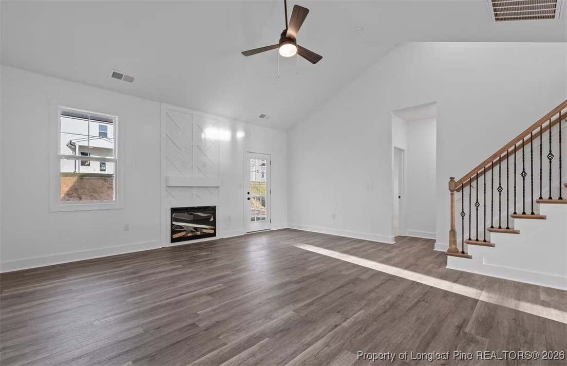 9844 Rockfish Road Raeford, NC 28376 - Photo 5 of 32 a view of an empty room with wooden floor fireplace and a window