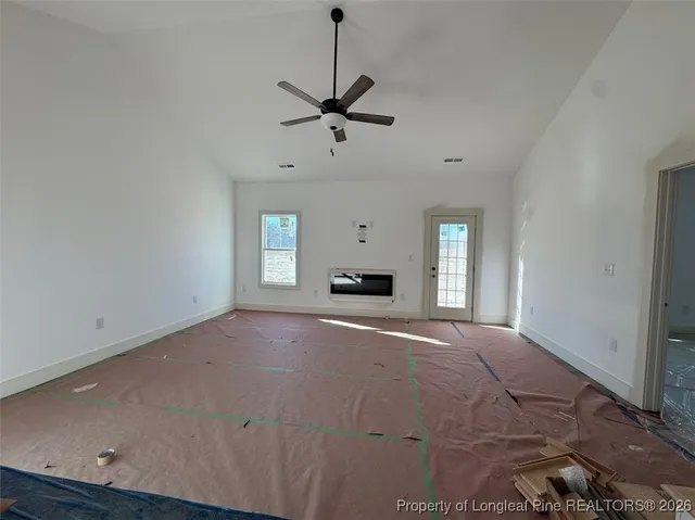 a view of empty room with a fireplace