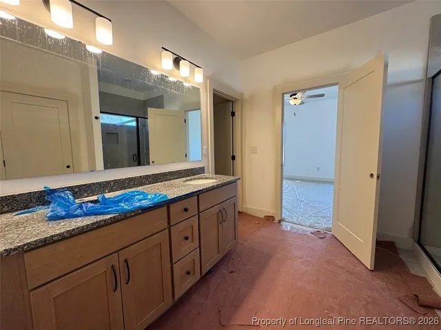 a spacious bathroom with a double vanity sink and a mirror