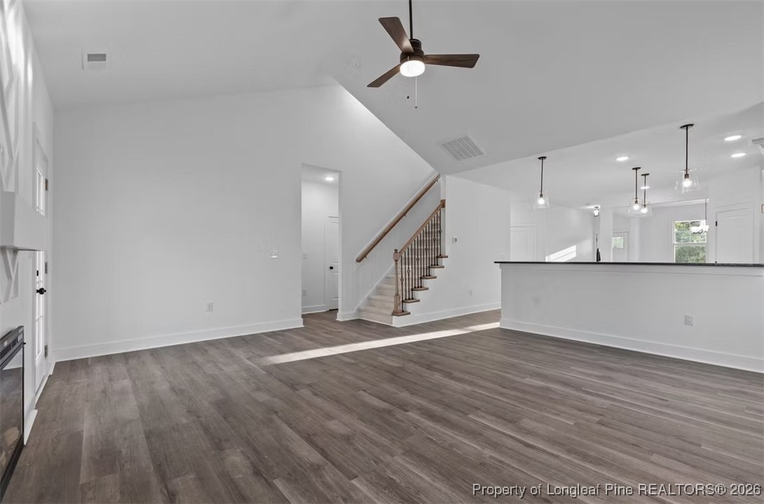 9844 Rockfish Road Raeford, NC 28376 - Photo 6 of 32 an empty room with wooden floor and staircase