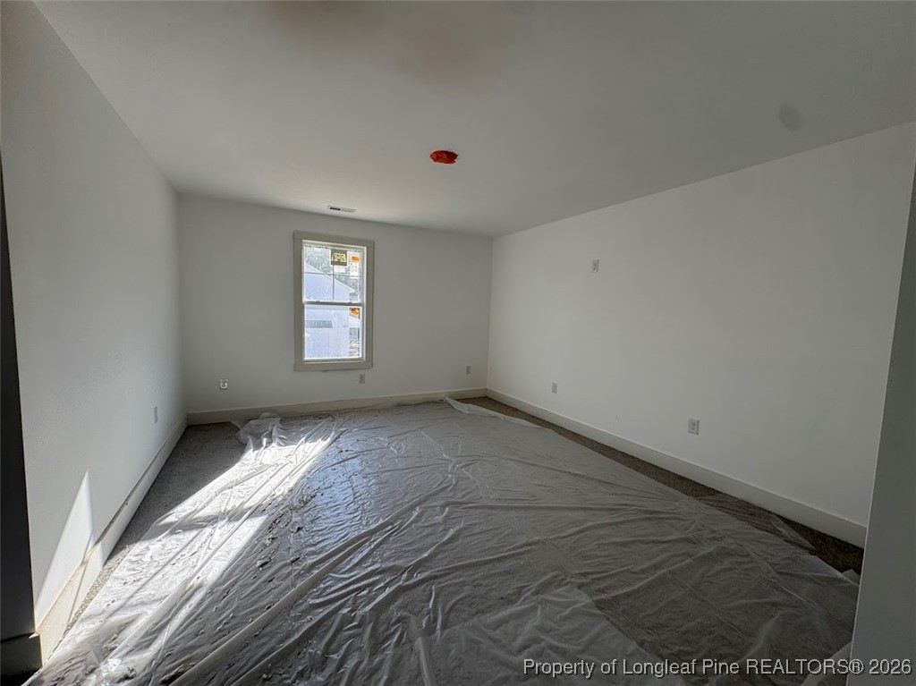 9844 Rockfish Road Raeford, NC 28376 - Photo 8 of 15 a view of empty room with wooden floor