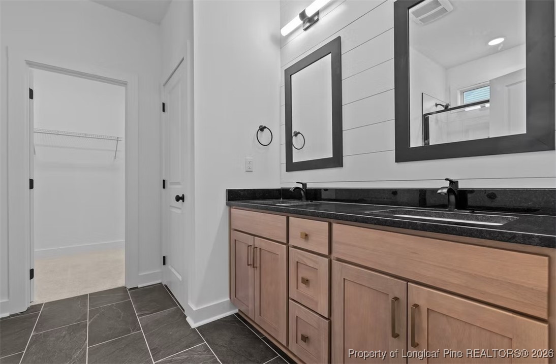 9844 Rockfish Road Raeford, NC 28376 - Photo 8 of 32 a bathroom with a sink and a mirror