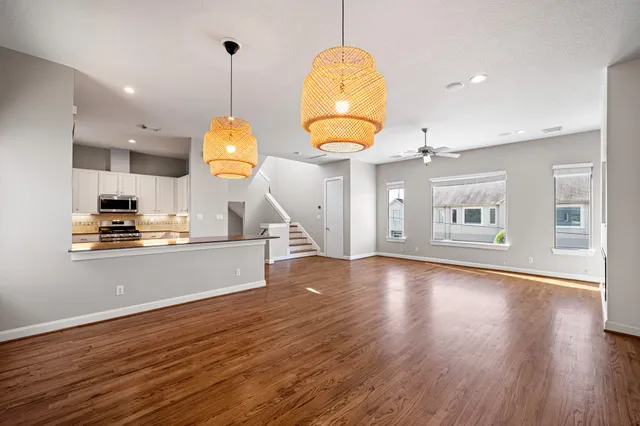 a view of a kitchen with wooden floor and a sink