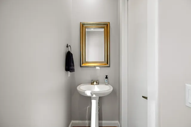 an empty room with windows and ceiling fan