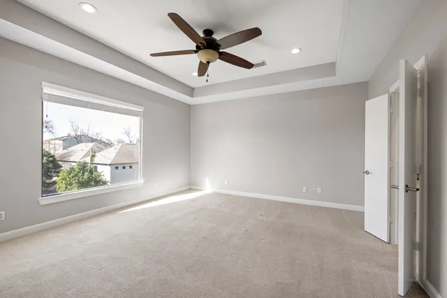 a view of a livingroom with a ceiling fan and window