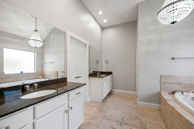 an empty room with a window and a ceiling fan