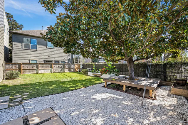 a view of a house with backyard and sitting area
