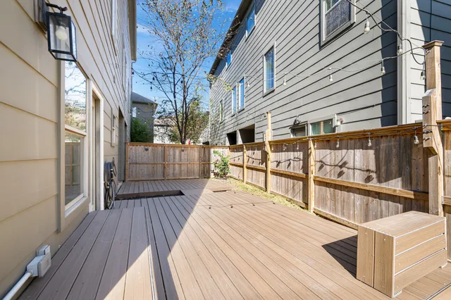 a view of a balcony with wooden floor and furniture