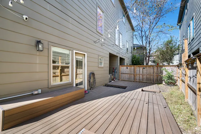 a view of pool with lawn chairs and plants