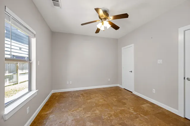 a view of room with window and ceiling fan