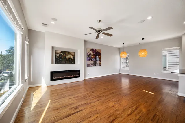 a view of a livingroom with furniture wooden floor and window
