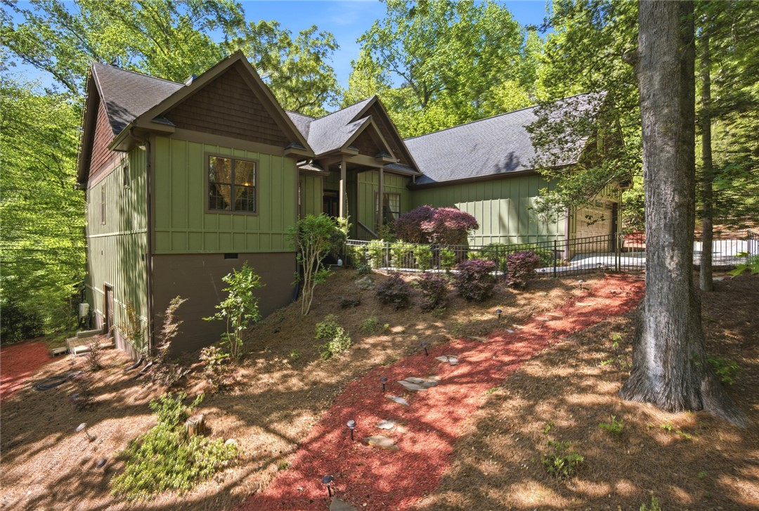 215 Inlet Pointe Drive Anderson, SC 29625 - Photo 43 of 47 This charming residence is nestled among mature trees, offering a tranquil retreat.