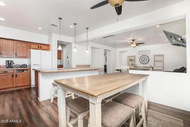 a bathroom with a granite countertop sink and a mirror with toilet