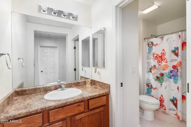 a view of a hallway with wooden floor and windows