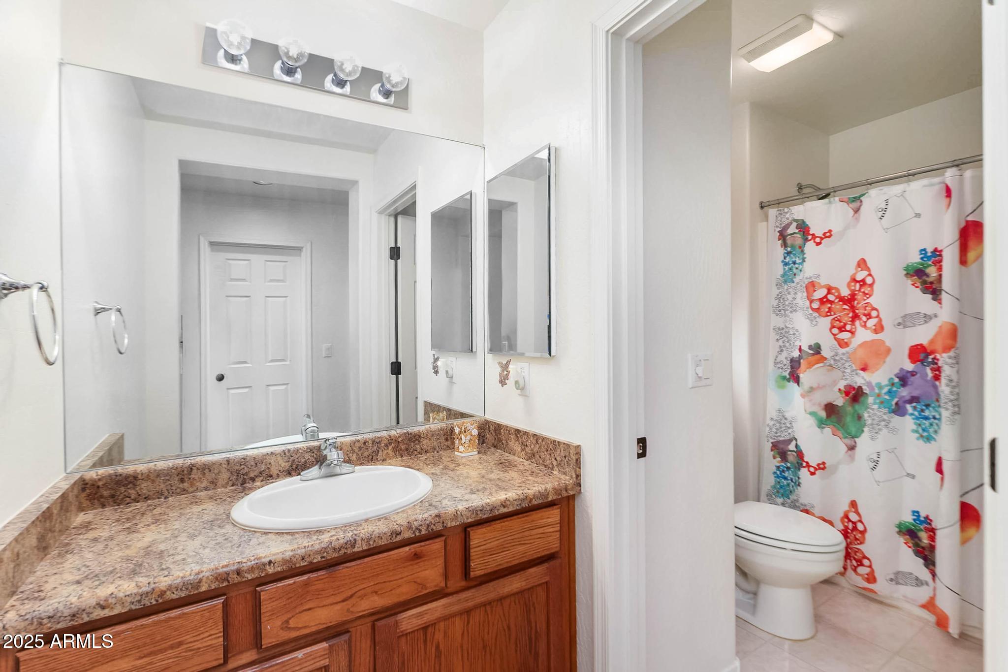 608 Bootleg Road Clarkdale, AZ 86324 - Photo 34 of 111 a bathroom with a granite countertop sink and a mirror with toilet