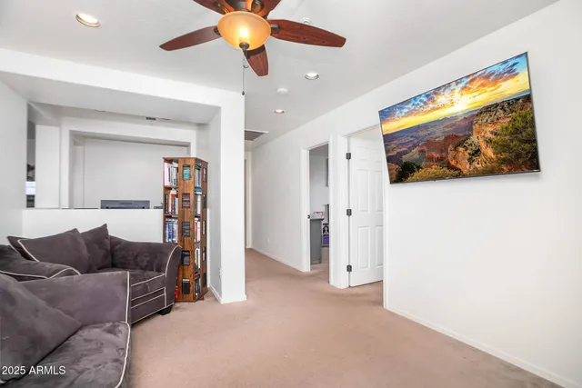 a bedroom with furniture and a chandelier fan