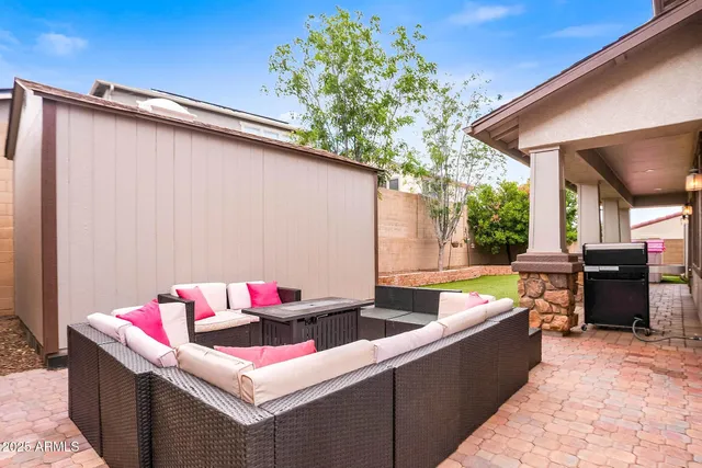 a living room with furniture and a ceiling fan