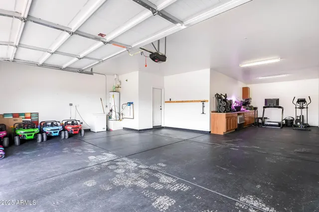an aerial view of a city with lots of residential buildings ocean and mountain view in back