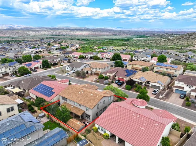 an aerial view of a residential houses with outdoor space and street view