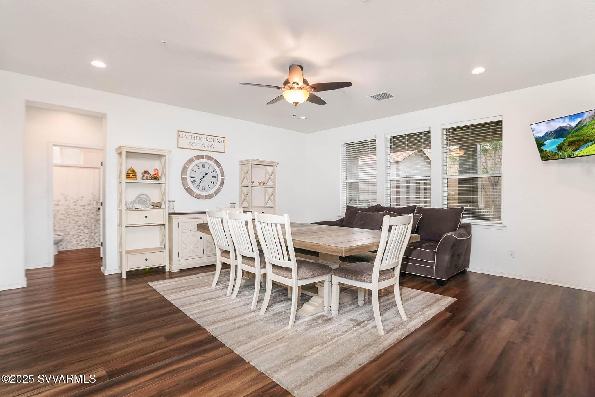 608 Bootleg Road Clarkdale, AZ 86324 - Photo 64 of 111 a dining room with wooden floor a chandelier a glass table and chairs