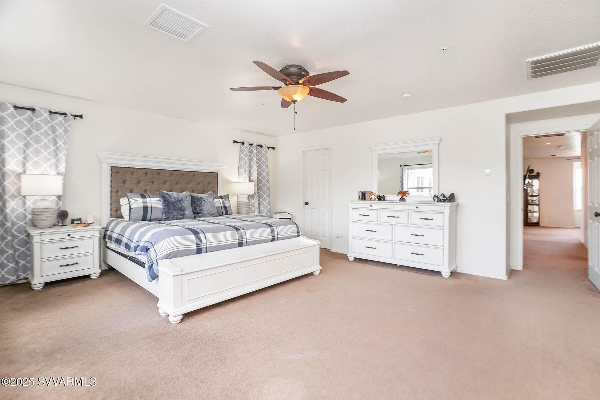 608 Bootleg Road Clarkdale, AZ 86324 - Photo 77 of 111 a bedroom with a bed and ceiling fan