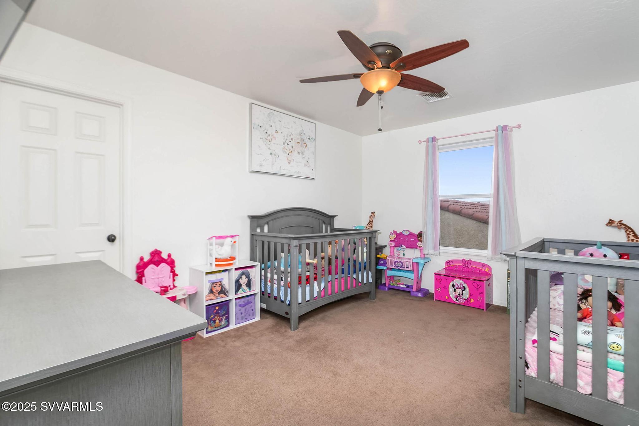 608 Bootleg Road Clarkdale, AZ 86324 - Photo 82 of 111 a bedroom with furniture and a chandelier fan