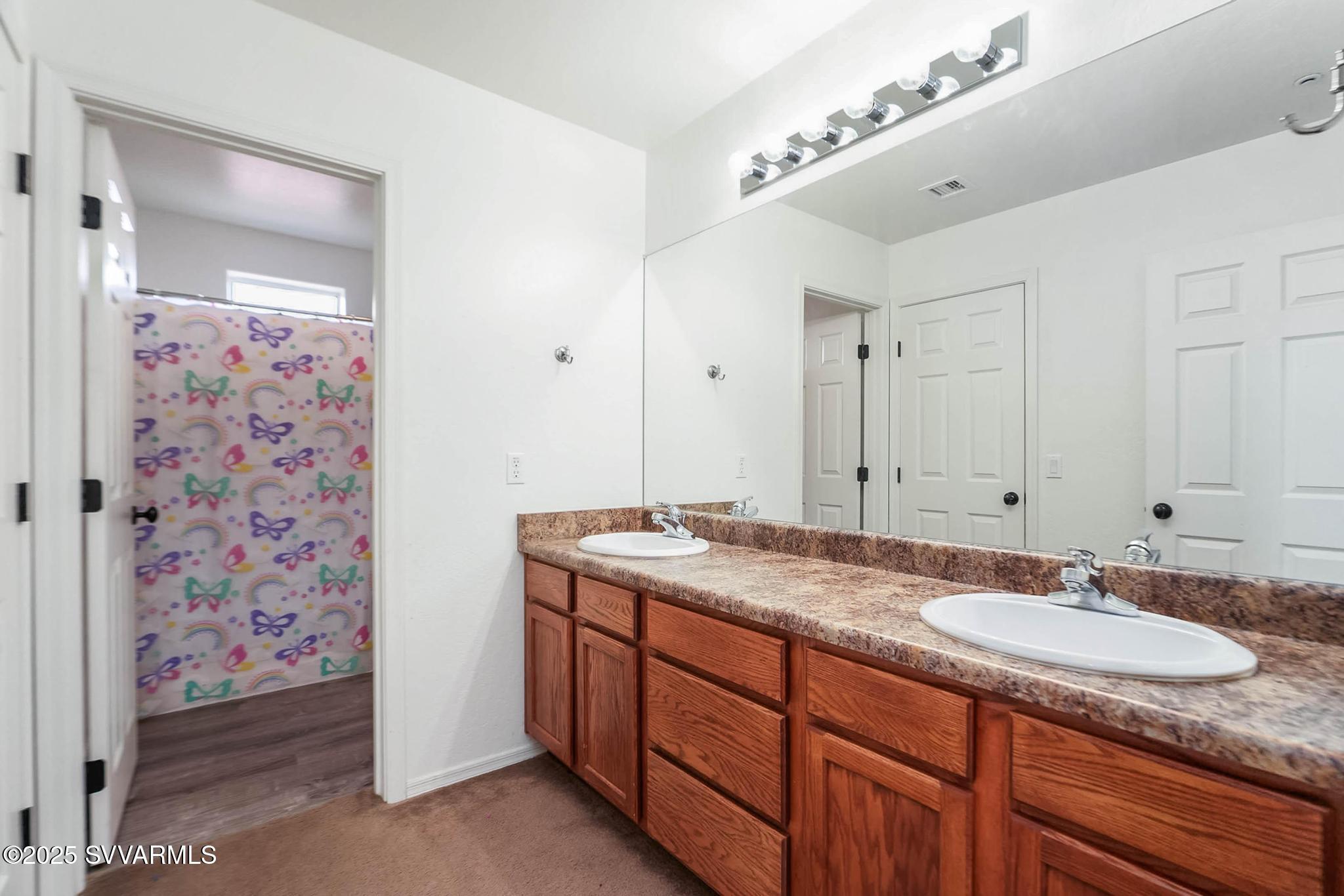 608 Bootleg Road Clarkdale, AZ 86324 - Photo 86 of 111 a bathroom with a granite countertop sink and a mirror