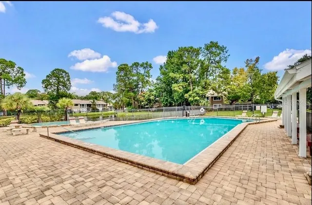 a view of a swimming pool with a lounge chairs