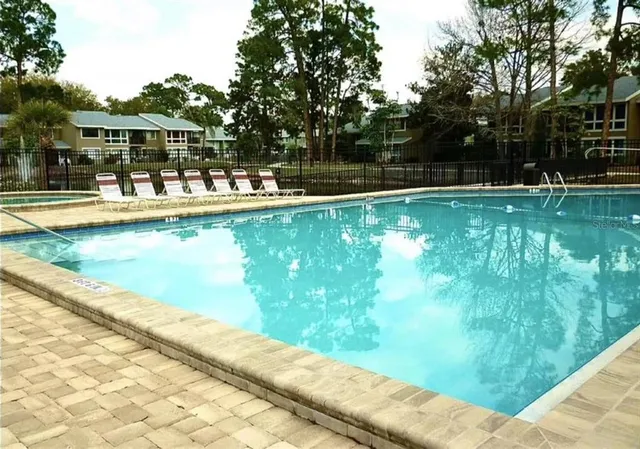 a view of swimming pool with outdoor seating and lake