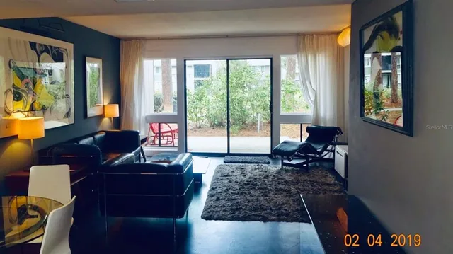 a living room with furniture and a large window