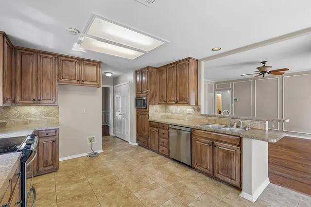 a kitchen with a sink refrigerator and cabinets