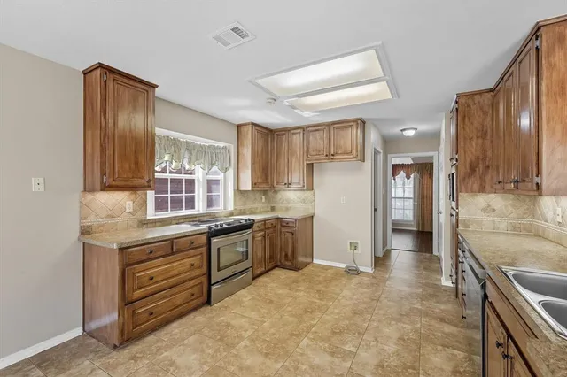 a kitchen with a sink stove and refrigerator