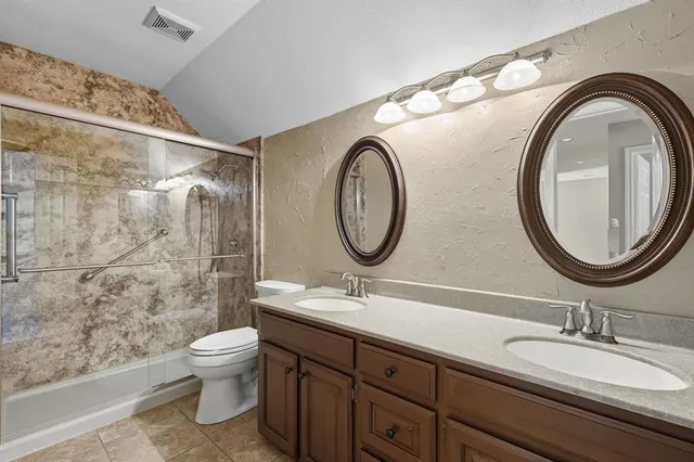 a view of an empty room with chandelier fan and a window