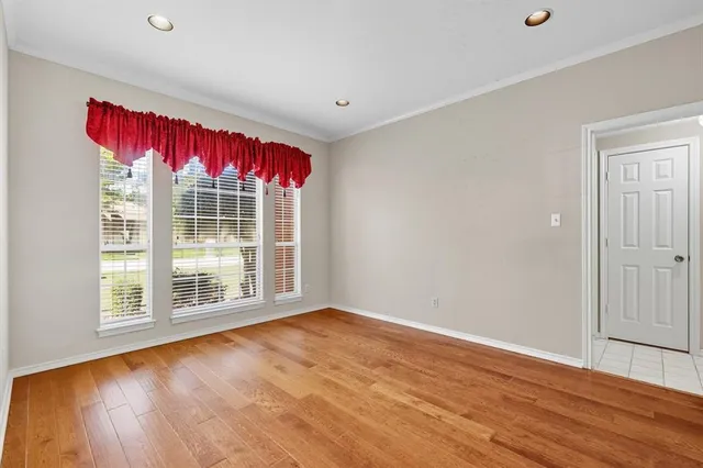wooden floor in an empty room with a window