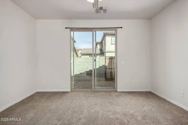 an empty room with sliding glass door and shower